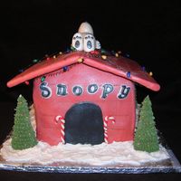Christmas Snoopy This is a Chocolate Cake, with Fondant on it. Snoopy and Candy Canes are Fondant, Wreath is Royal Icing, Christmas Trees are Sugar Cones...