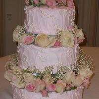 Fluffy Pink Pearl Wedding Cake This was my first wedding cake ever. The pearls were fondant with luster dust. I enjoyed making it but I was unable to finish and put the...