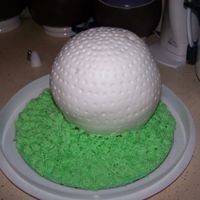Golf Cake Made with Wilton sports ball pan. Covered in fondant, grass in stiff buttercream.