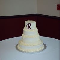 Red Velvet Cake With Butter Cream Icing. This cake was a simple design that the bride chose. Red velvet cake with cream cheese and nut filling and butter cream on the outside.