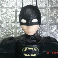 Batman First attempt at Batman. I would do a few things differently next time. The ears, cape, and symbol are fondant. The head is styrofoam wig...