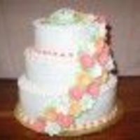 Spring Wedding Cake cascading spring flowers down buttercream iced cake