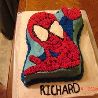 Spiderman A sheet cake with Spiderman on top.