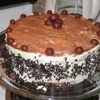 White Chocolate Genache Butter cake with chocolate and raspberry Genache filling; White chocolate Genache Chocolate shavings melted chocolate spread on top with...