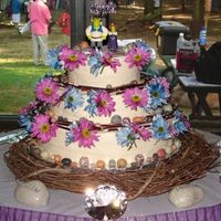Medieval Wedding Cake All Buttercream frosting with Marble cake... for a Medival Theme Wedding. The flowers are daisies, with sticks and chocolate rocks. Thanks...