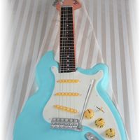 Fender Stratocaster Guitar Made this guitar for my sister in laws brother's 40th LOL!!gumpaste and fondant accents ...everthing was edible except for the strings...