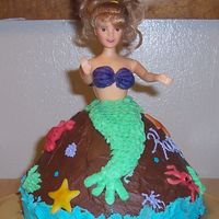 Mermaid Barbie I made this for my niece's fifth birthday. The cake is iced with buttercream icing. The creatures are made with fondant and her tail...