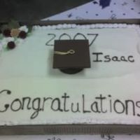 Second Grad Cake This is the other cake that I had to decorate. Very very simple.... lettering is done in chocolate ~ the cap is in chocolate ~ the flowers...