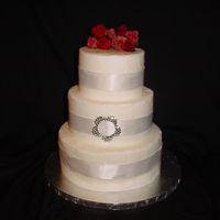 First Wedding 6,8,10 Buttercream, Satin Ribbon, Silk Roses and Hand-made Crystal Buckle. Had a little trouble with smoothing buttercream, all in all, I...