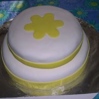 Yellow Flower top layer 8in white cake -bottom layer 12in lemon cake covered in MMF