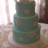 Snowflake Cake This is one of my displays for a Bridal Fair. It is a 6,8 and 10 inch cake done in fondant. The snowflakes are done in royal icing...