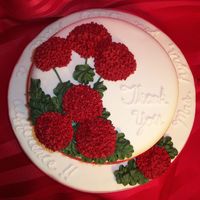 Red Geraniums Cake covered in MMF. Flowers made with Royal icing.
