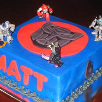 Transformers transformers cake. buttercream with fondant logo cut out by tracing over wax paper.