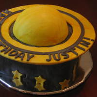 Saturn marshmallow fondant on square cake. half ball cake on top covered in yellow mmf. ring was cut out of cardboard and then covered in mmf.