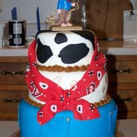 Cowboy Birthday My dad's 80th Birthday cake. Covered in fondant. Middle one has horse shoes drawn on with edible markers.