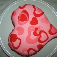 Valentines First Valentines cake. Chocolate cake. Pink Grand Marnier Buttercream. White Fondant with red coloring added, as well as red fondant.