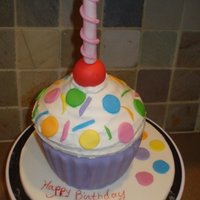 Jumbo Cupcake This was a last minute cake for a birthday dinner. Decorated in about an hour. Vanilla cake with Buttercream and fondant covered. Candle...