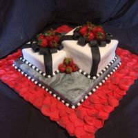 Black And White Cake W/strawberries This was done in fondant. The bottom marble cake is chocolate and the top two square cakes are white. This was my first time using fondant...