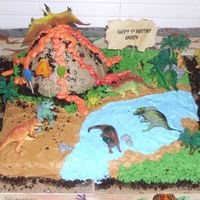 Dinosaur Cake This was for a four year old boy. I used the wonder doll cake pan for the volcano. I used buttercream and decorators cream cheese icing....