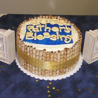 Father's Blessing Cake Double layer 10" rounds, Kalua fudge and white Kalua, covered in cream cheese frosting and surrounded with pirouettes and gold ribbon...