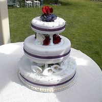 Dsc00041.jpg a red velvet with cream cheese filling, covered in fondant. done for my niece's wedding.