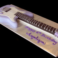 Purple Guitar Life sized electric guitar carved from chocolate cake and covered in fondant. The strings were the trickiest part of this cake, and I ended...