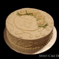 Scrolls Simple ivory buttercream cake with buttercream roses.