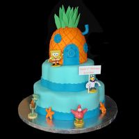 Sponge Bob Fondant covered petal pans and pineapple. I used the doll pan and did a lot of carving. Gumpaste accents and the figures are toys.