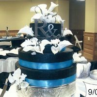 Black And Turquoise Chocolate cake with black buttercream- artificial ribbon, callas and stephanotis