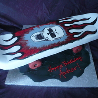 Skateboard Fondant covered skateboard cake with cereal treat wheels.and handpainted skull and flames. Fun one to make!