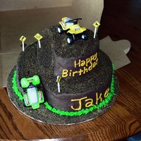 Four-Wheeler Cake Chocolate cake on bottom and vanilla on top w/ chocolate buttercream. Dirt is made out of crushed graham crackers and crushed oreo cookies...