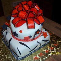 Orange Bow cake is covered with chocolate fondant and the bow is made of gum paste