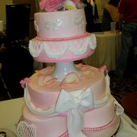 Swags And Bows cake is in butter cream with fondant decorations