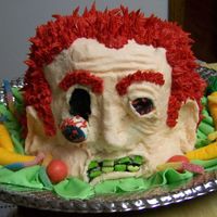 Zombie carved head, with crusting buttercream frosting. fondant veggies