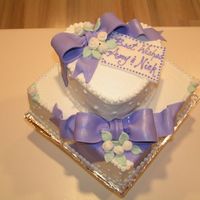 Wedding Shower Cake My first cake since I had my baby girl in December. It has fondant bows and roses. The icing is butter cream. I got the idea from a similar...