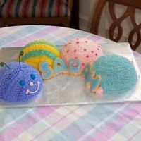 Catipilliar.jpg This was for my other nieces 1st birthday. We gave her the head as a smash cake, but she was very dainty about it.