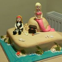 Pirates And Mermaids This cake was for a little girl having a pirate and mermaid party. She wanted lifelike models of her in a mermaid costume and her sister as...