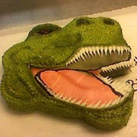 Dino Head This is a 2-dimensonal cut out of a dinosaur head, iced in buttercream and hightlighted with an airbrush.