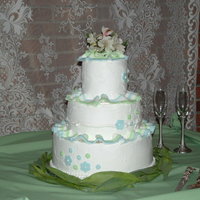 Three Tier, Round Wedding Cake Buttercream wedding cake with fondant decorations. My very first tiered cake. A little bit of a blowout from the mm filling in the second...