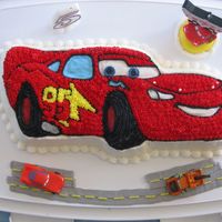 Lighning Mcqueen Cars cake with a few extras.