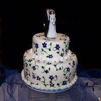 Blue Flowers Hand painted fondant. Buttercream borders. (Picture from the 2006 wedding show I was in) I WELCOME ALL COMMENTS!!!!