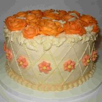 Various Shades Of Orange Flowers Chocolate cake with chocolate ganache and raspberry filling covered with buttercream icing.