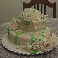 For A Couple Who Is Celebrating Their 15 Years Anniversary. vanila cakes covered in mmf. Roses rnd daisies are made of gumpaste.