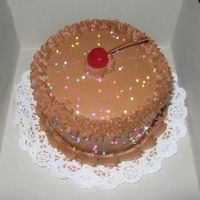 Chocolate Buttercream B-Day Cake Chocolate buttercream cake, 2 layer chocolate cake w/buttercream chocolate in center as well. Top of the cake was a disaster, as it broke,...