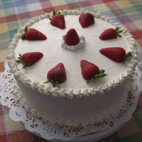 Strawberries And Stars White scratch cake with strawberries and whipped cream in the center. Outside is whipped cream as well, with strawberry halves outlining...