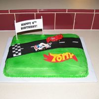 Race Car Track Buttercream frosted vanilla cake with fondant road and name.