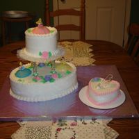 Disney Princess Cake I made this for my two year old cousin. Regular buttercream and white cake with a smash cake. I got the toppers at Wal-Mart in the bakery...