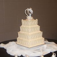 My 1St Wedding Cake!! This is my first wedding cake. I'm pretty happy with it. It was definately a learning experience. The top and bottom tiers are WASC,...