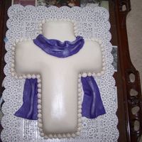 Cross With Purple Drape Vanilla with Vanilla pudding filling covered in fondant. Pearl luster dust covering