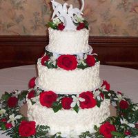 Red & White Wedding Cake tower style wedding cake with fresh red & white flowers between the tiers